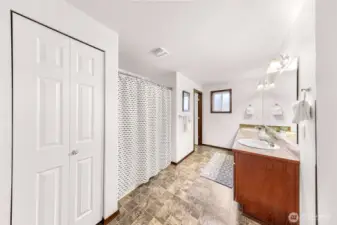 A very spacious bathroom!  Linen closet to your left, tub/shower and it's own toilet room with a door.  Two sinks along the large vanity and wait until you see the closet to your right!