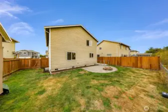 In the far left corner, you'll find the gate to the gravel parking space.  Patio to your center right.
