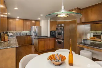 Kitchen features under cabinet lighting and a built-in desk.
