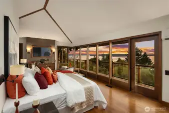 Primary bedroom features a vaulted ceillings, a hidden TV behind the mirror, a fully remodeled ensuite with two doors out to your private upstairs deck.