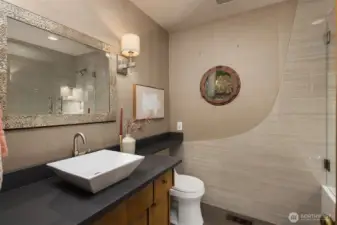 Main level bathroom was fully remodeled with ceramic tile and port window.