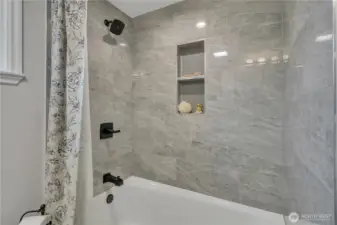 Simple, elegant cast iron tub and shower with clean lines.  It's just right for this home.