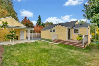 The backyard is level and has a covered patio attached to the garage.