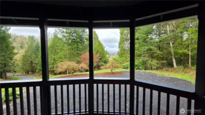 View from the front porch overlooking the beautifully, wooded surroundings and the newly paved private driveway.