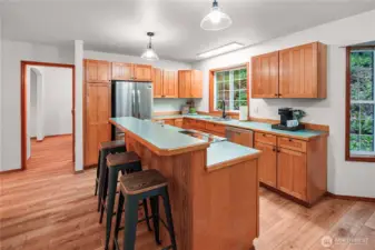 Bright kitchen with eating bar and brand new refrigerator and range/oven. Ready for everyday cooking and entertaining.