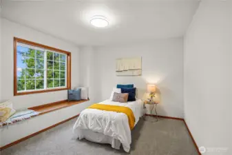 Cozy bedroom #2 with built in seating bench under the window, complimented by new carpet and fresh paint for a comfortable retreat.