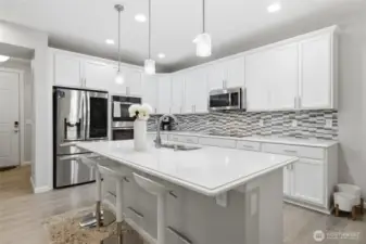 Stunning kitchen with center island, tons of storage and quartz counters