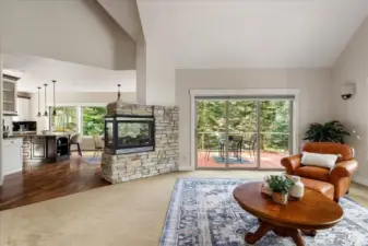 Views from the living room looking towards the kitchen with a central propane fireplace.