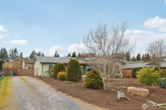 Shared driveway that leads to a one car garage and attached carport.