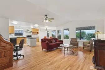 Open concept living room flowing into the kitchen and dining area.