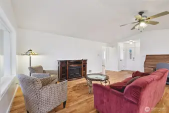 Living room looking towards the front door and hallway to the left.