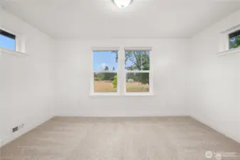 Upstairs bonus room alcove with large windows showcasing views of grazing cows across the street and a stunning backdrop of Mount Rainier.