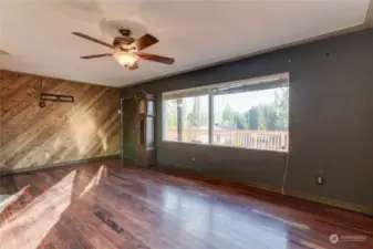 Note the ceiling fan and decorative wood wall.