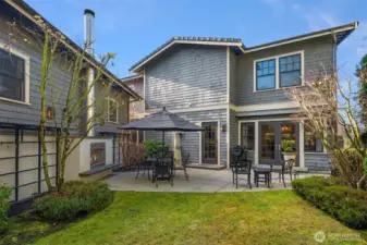 Side yard with outdoor fireplace and patio adds charm. Have a seat by the fire