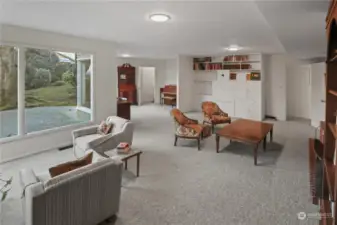 Daylight basement with rec room, bedroom, bathroom, and large storage room.