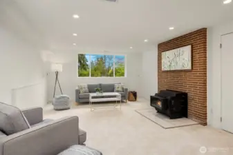 Lower level family room with wood burning fireplace stove