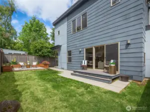Private backyard with patio and deck with plenty of space to play.