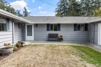 A welcoming entry with a wide walkway invite you into the home.