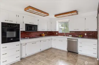 Step into this great kitchen! With loads of prep space and storage, you're going to love cooking here!