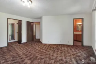 A different perspective of the primary bedroom. This image features the en-suite bathroom and closet.