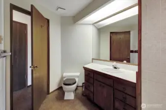 Bedroom #3 features a full en-suite bathroom that includes an additional exit to the hallway.