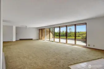 MIL living room with a wall of windows and a slider to the rooftop deck.