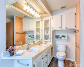 Primary bath features designer Moen faucets, dbl sinks and expansive mirror.