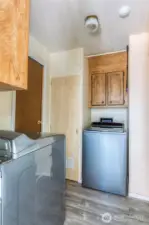 Laundry area w/storage and upright freezer {not shown}, all stay.