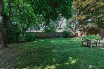 Fully fenced yard, beautiful mature trees, raised gardens and storage shed or workshop.