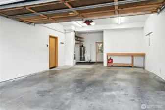 Spacious single car garage w/ workbench and room for stroage.
