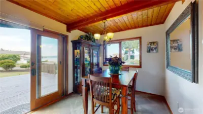 Charming dining area with wood-beamed ceiling and natural light