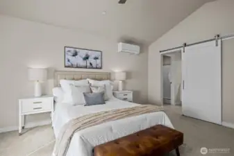 Barn door leads to primary bath
