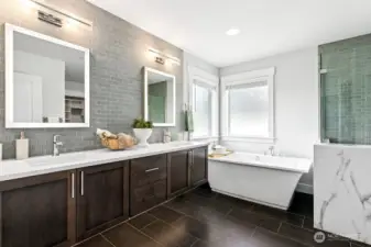 Primary bathroom with heated floors, soaking tub, back-lit mirrors, and floating vanities