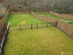 Huge yard-which is very rare in new construction! The upper portion is level and fenced, the lower portion is a blank canvas for whatever you envision!