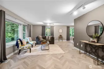 As you enter the front door you will notice the beautiful designer flooring and modern paint colors along with the many windows which were all replaced in 2021.