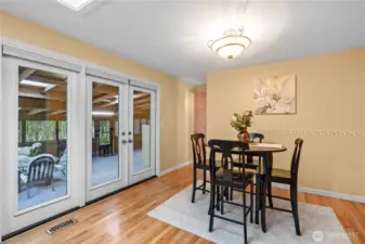 Additional dining area off of kitchen and leading into sunroom.