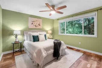 Primary bedroom with closet organizer system and attached bath.