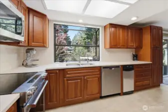 Kitchen with cherry cabinets and quartz counters