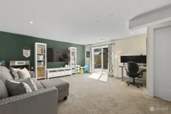 The fabulous space on the lower level has plenty of room for play, and office nook, and has a slider to the rear yard patio.