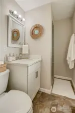 Primary 3/4 bathroom w/ quartz counters & tile surrounds