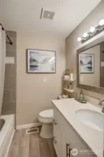 Full guest bathroom w/ tile surround & quartz counters