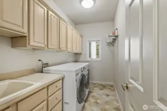 The main floor is completed with the guest ½ bath and laundry room with lots of cabinets and a utility sink.