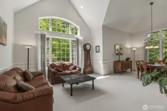The open and spacious formal living and dining rooms boast tall vaulted ceilings and wainscoted walls.