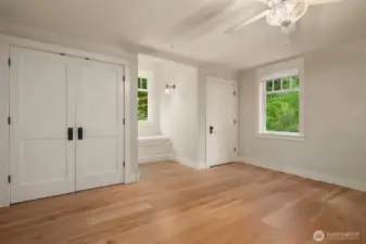 Upper guest bedroom has double-closets and built-in nook seating with storage
