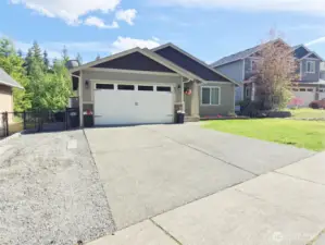 RV parking just to the left of the driveway.