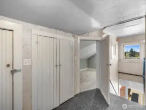 A peek at the top of the stairs—through the open door, you'll find a bonus storage room that already includes a toilet. With a little creativity and vision, this space could easily be transformed into a full bathroom, adding both function and value to the home!