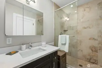 Spa-like 3/4 bathroom with tiled shower and double head rain shower.