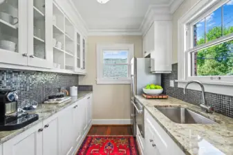 High-end cabinets, granite counters, designer backsplash, and warm fir floors.
