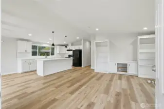 The open kitchen flows seamlessly into the bright and airy living area.