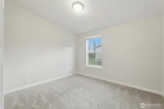 This photo showcases the second bedroom, carpeted for comfort and an inviting atmosphere.